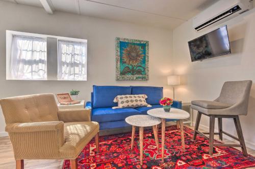 a living room with a blue couch and two chairs at Claires Cottage about 4 Mi to Downtown Greenville! in Greenville