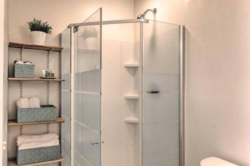 a shower with a glass door in a bathroom at Charming Cottage about 4 Mi to Downtown Greenville! in Greenville