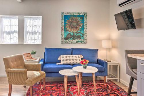 a living room with a blue couch and a table at Claires Cottage about 4 Mi to Downtown Greenville! in Greenville