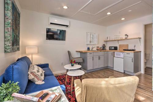 a living room with a blue couch and a kitchen at Claires Cottage about 4 Mi to Downtown Greenville! in Greenville