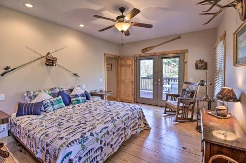 a bedroom with a bed and a ceiling fan at The Captains Quarters in Rogers with Covered Porch! in Rogers