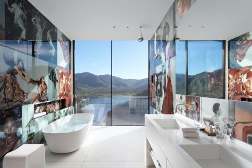 a bathroom with two sinks and a large window at Vik Chile in San Vicente de Taguatagua