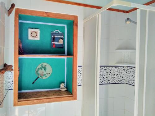 a bathroom with a shower and a blue wall at Vinciucci in Ispica