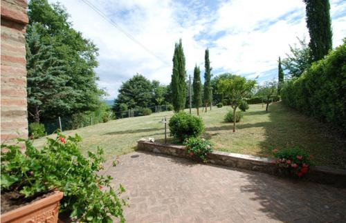 a garden with flowers and trees and a brick walkway at Verzure in Montingegnoli