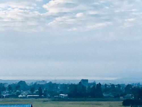 a view of a field with a city in the background at Milimani apartments10 in Nakuru