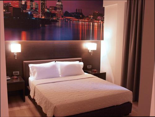 a bedroom with a bed with a view of a city at Athens City Hotel in Athens