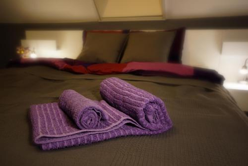 a purple towel sitting on top of a bed at Bed & Badacsony in Badacsonytördemic