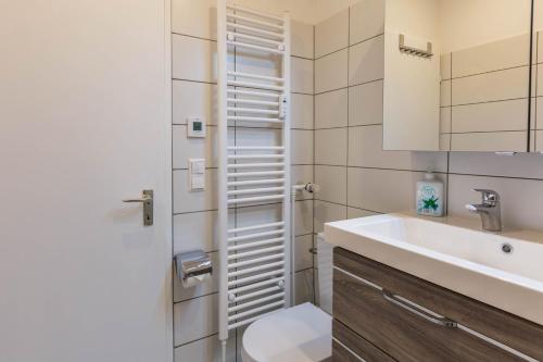a bathroom with a toilet and a sink at Ferienwohnung Urs in Schönwald