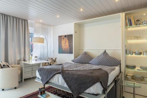 a bedroom with a bed and a desk in a room at Ferienwohnung Urs in Schönwald