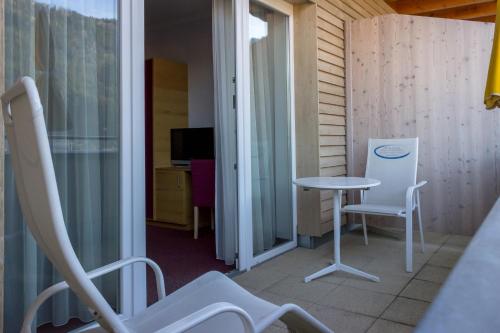 a balcony with a table and chairs in a room at Gesundheitsresort Bad St. Leonhard in Bad Sankt Leonhard im Lavanttal