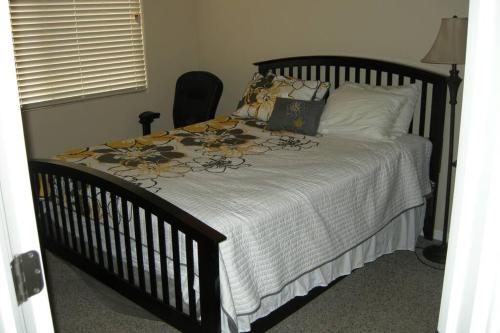 a bedroom with a bed with a black crib at Mesquite Nevada Vacation Rental - Ground Level and double car garage in Mesquite