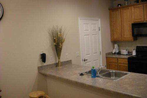 a kitchen with a sink and a vase of flowers on a counter at Mesquite Nevada Vacation Rental - Ground Level and double car garage in Mesquite