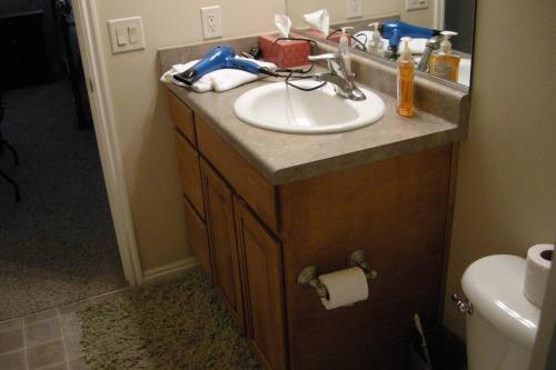 a bathroom counter with a sink and a toilet at Mesquite Nevada Vacation Rental - Ground Level and double car garage in Mesquite