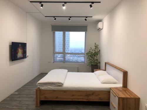 a bedroom with a bed and a window at 4 rooms apartment with a view of the Dnieper River in Kyiv