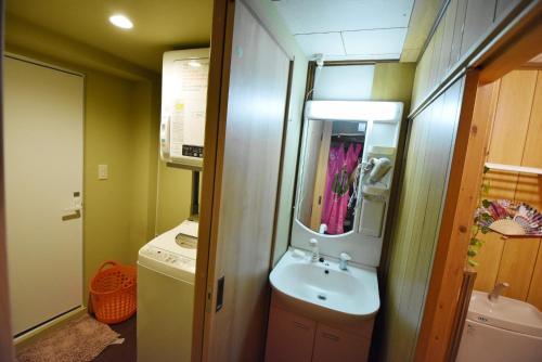 a small bathroom with a sink and a mirror at Oyado Sanjyo-Machiya - Vacation STAY 96740 in Kyoto