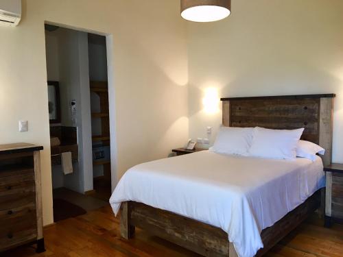A bed or beds in a room at Hacienda Soltepec Suites Campo de Golf