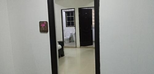 a bathroom with a mirror and a toilet in a room at Events & Suites in Abuja