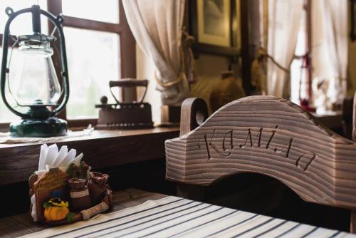 a wooden boat sitting on a table next to a lamp at Готель-ресторан Каміла in Polyana