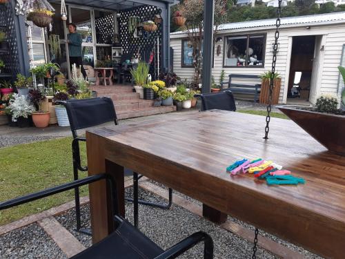 a wooden table in a yard with chairs at rooms with a view in Haywards
