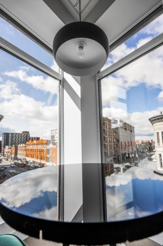 a large window with a view of a city at Hotel Oui GO! in Trois-Rivières