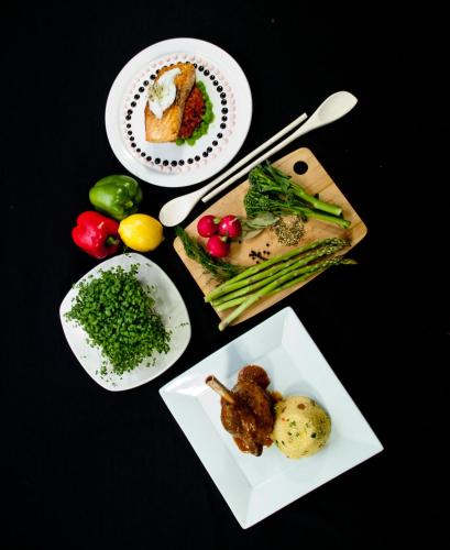 a table with plates of food and plates of vegetables at Best Western Premier Freeport Inn Calgary Airport in Calgary