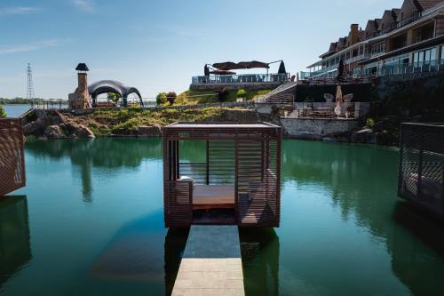 a bird cage in the middle of a body of water at Спа-Готель Потоки Хауз in Kam”yani Potoky