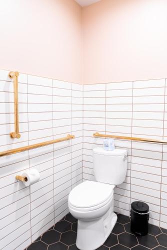a bathroom with a white toilet in a room at Bradford House, a Member of Design Hotels in Oklahoma City