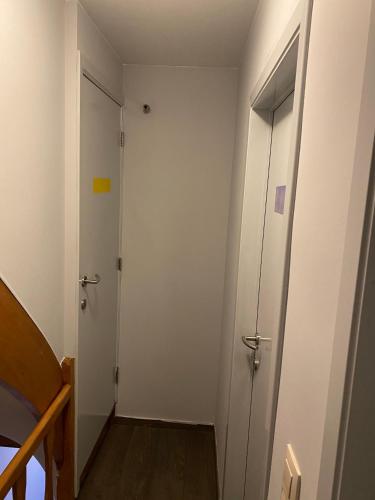 an empty hallway with two doors and a staircase at Chez Mémé in La Roche-en-Ardenne