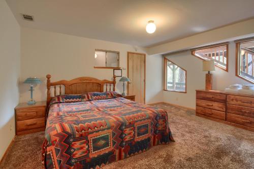 a bedroom with a bed and a dresser and windows at 99 Yosemite Mountain Lodge in Wawona