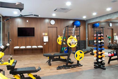 a gym with several treadmills and equipment in a room at Exclusive Gramado Hotel & Spa by Gramado Parks in Gramado