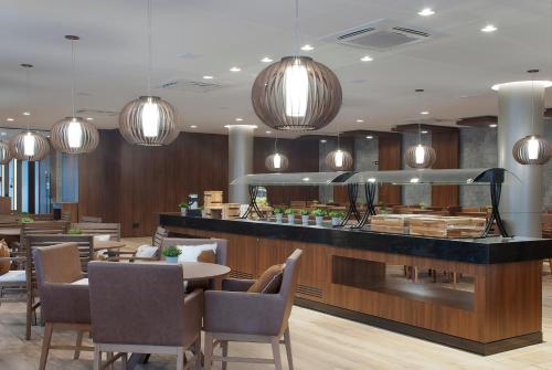 a restaurant with a table and chairs and lights at Exclusive Gramado Hotel & Spa by Gramado Parks in Gramado