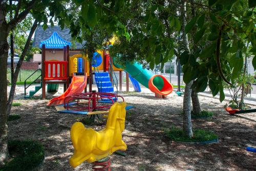 a playground with colorful playground equipment in a park at Exclusive Gramado Hotel & Spa by Gramado Parks in Gramado