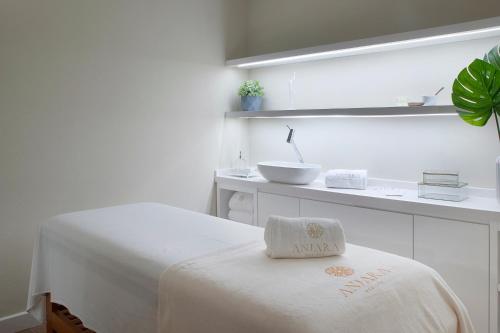 a white room with a bed and a sink at Exclusive Gramado Hotel & Spa by Gramado Parks in Gramado