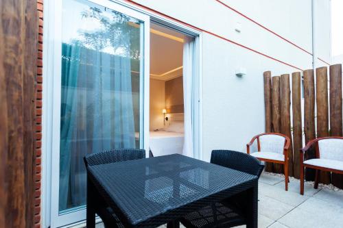 a black table and chairs on a balcony at Vistabela Resort & Spa in São Sebastião