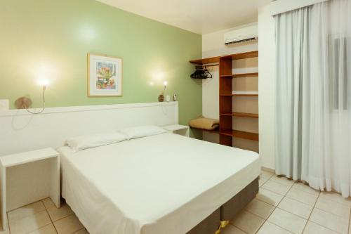 a bedroom with a large white bed in a room at Vistabela Resort & Spa in São Sebastião