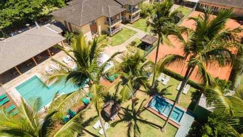 an aerial view of a resort with palm trees and a pool at Vistabela Resort & Spa in São Sebastião