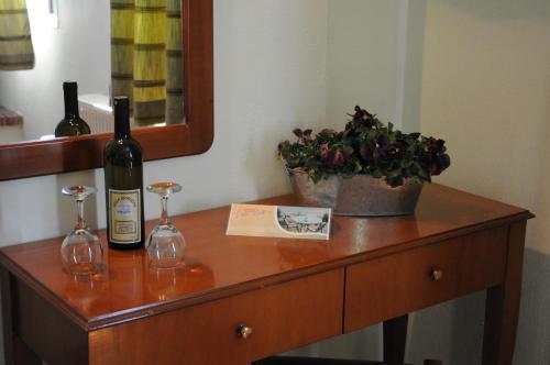 a table with two bottles of wine and a plant at Horizon Hotel in Ioannina