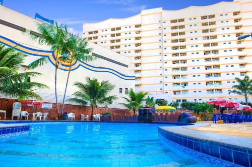 a swimming pool in front of a hotel at Golden Dolphin Grand Hotel via Giro ImobTech in Caldas Novas