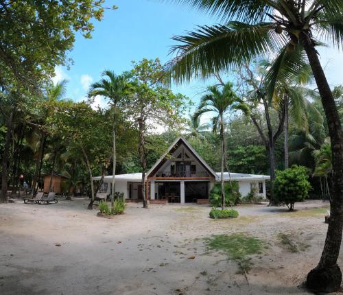 uma casa no meio de uma floresta com palmeiras em Casa Cecilia Beach Front em Santa Teresa