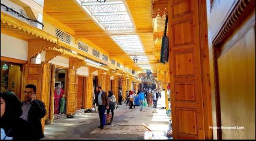 a group of people walking down an alley in a building at Dar Bennis médina in Rabat