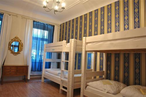 a bedroom with two bunk beds and a mirror at Lotte - The Backpackers in Heidelberg