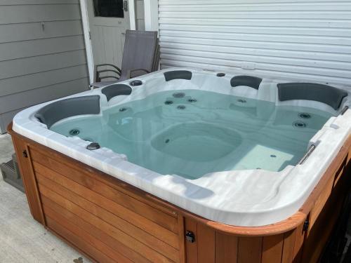 a jacuzzi tub sitting on the side of a house at Whakatane B&B in Whakatane