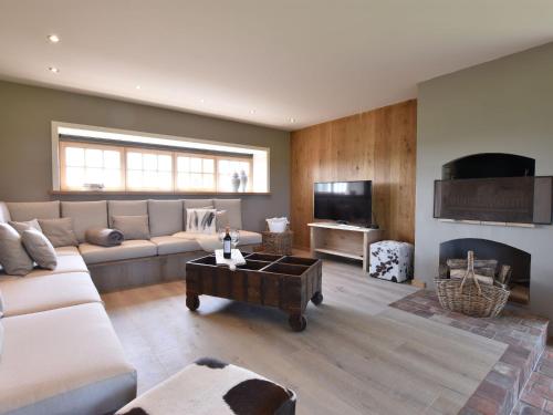 a living room with a couch and a fireplace at Beautiful Holiday Home with Terrace Garden in Diksmuide