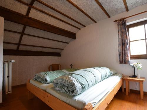 a bed with pillows on it in a room at Tranquil Holiday Home in Houffalize with Barbecue in Nadrin