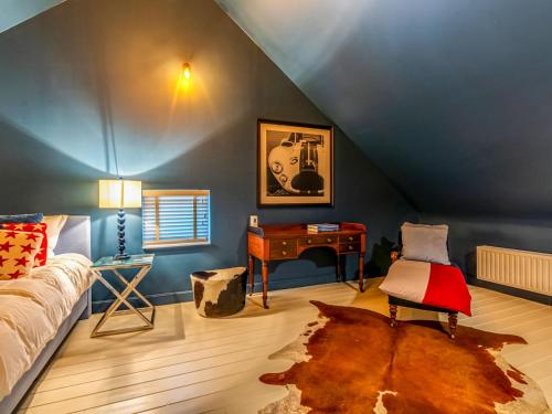 a bedroom with a bed and a desk in a attic at Luxurious holiday home in Heers with terrace in Mettekoven