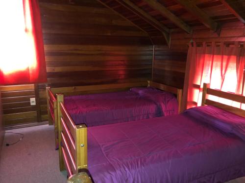a bedroom with a bed and a lamp in it at Hotel Termal Dayman in Termas del Daymán