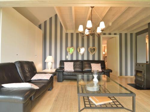 a living room with a couch and a table at Chalet with Valley Views, in Malmedy