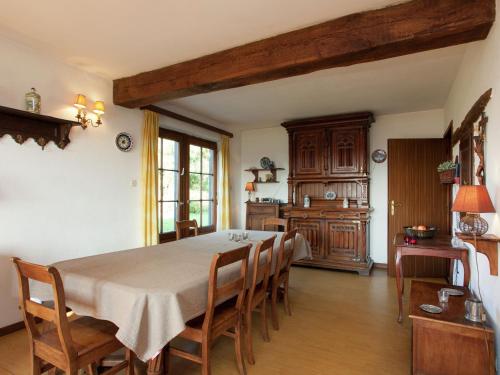 a dining room with a table and some chairs at Friendly and rustic family home with fireplace in Stavelot