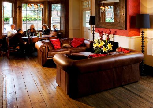 a living room filled with furniture and a fireplace at The Victoria in London