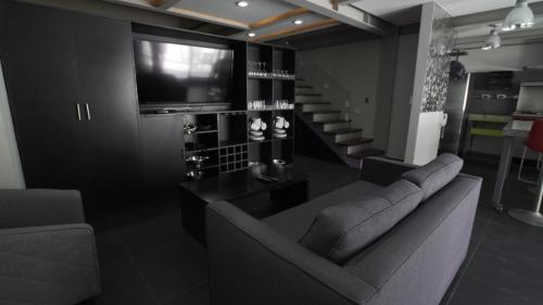 a living room with a couch and a television at 2 Bedroom Garden House Polanco in Mexico City